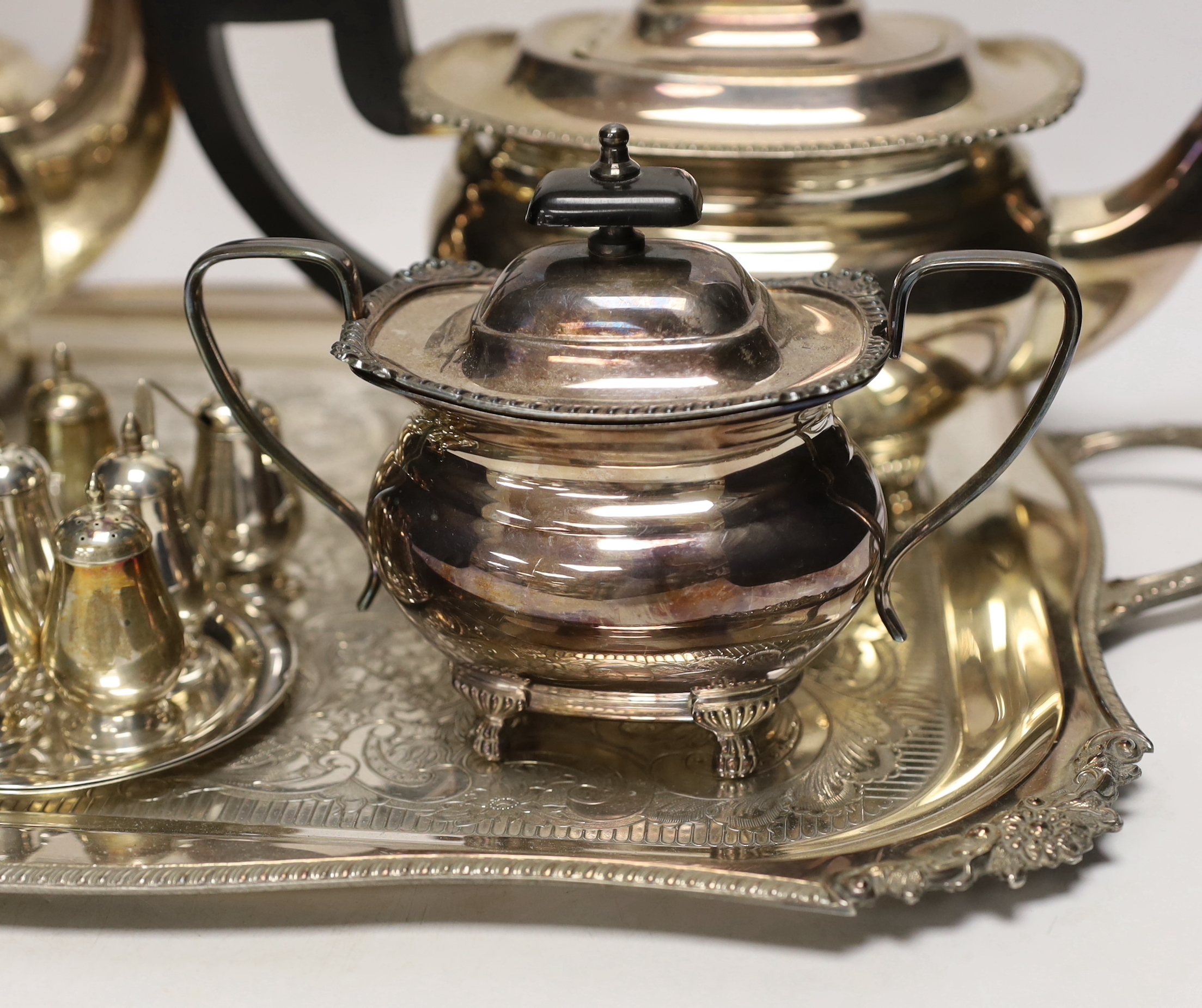 A plated tea / coffee set with ebonised handles and two Sterling condiment sets